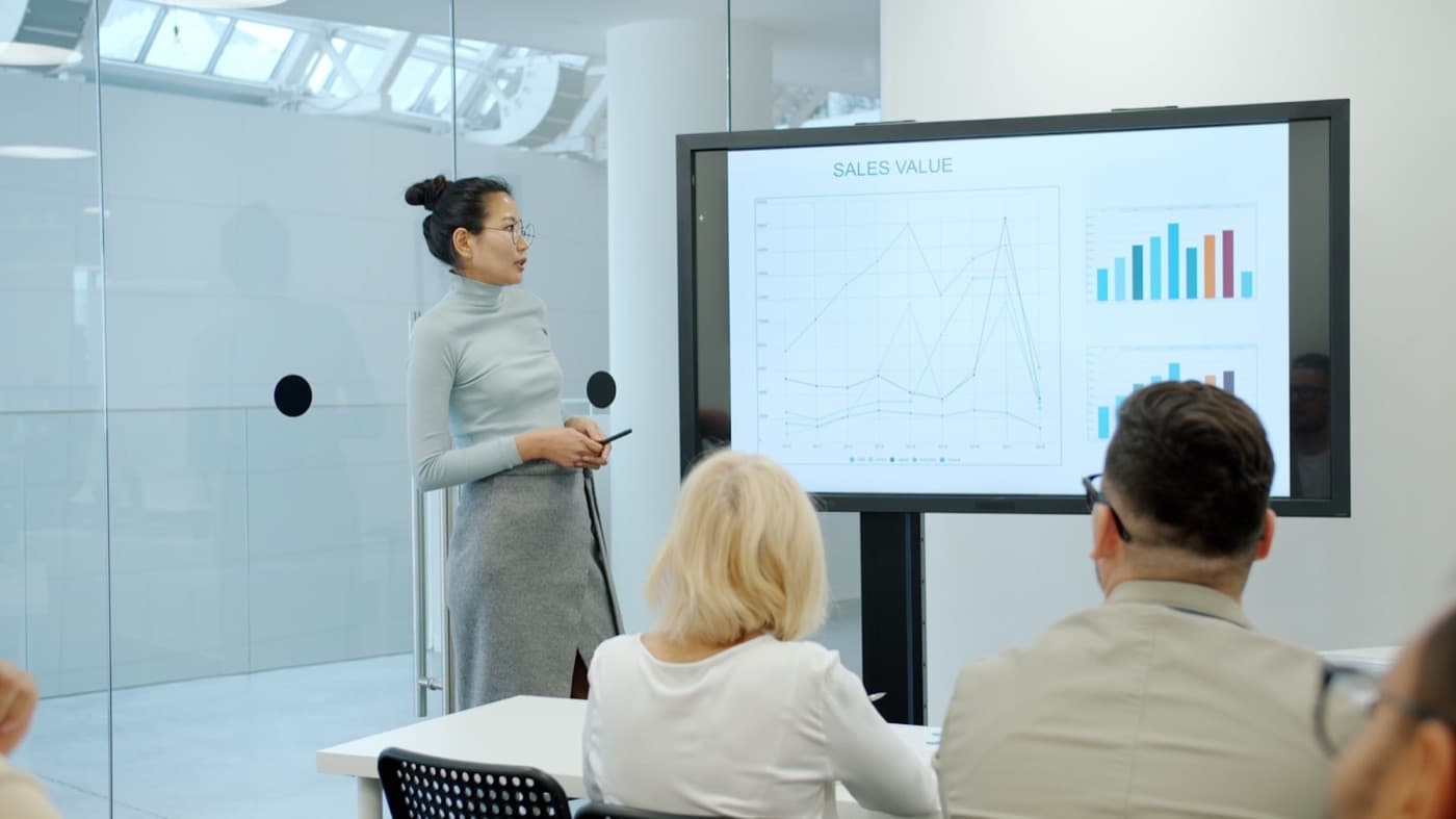 Instructor presenting to a class of professionals